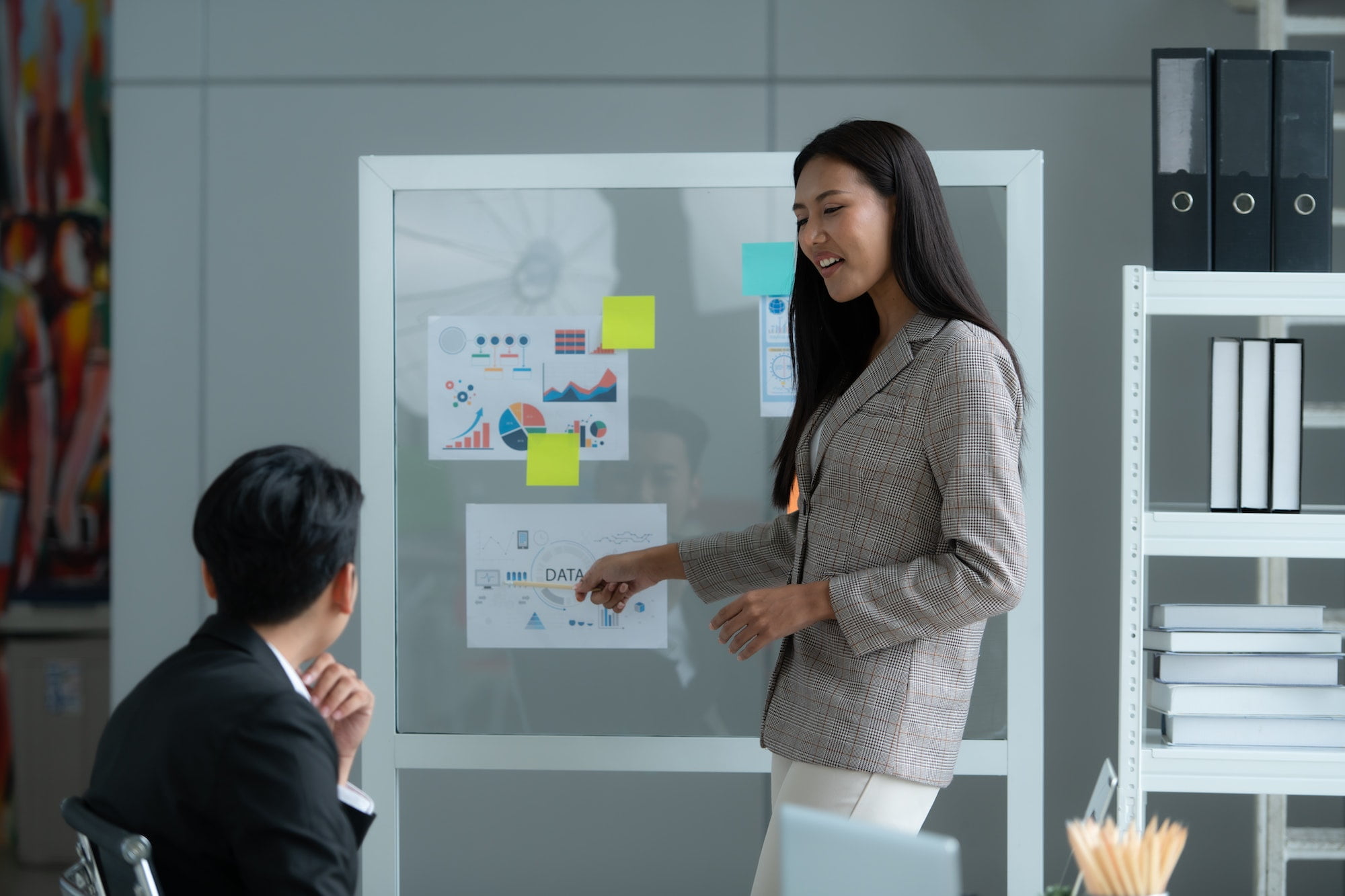 A group of young Asian entrepreneurs. Meeting to review stock investment data in a meeting room