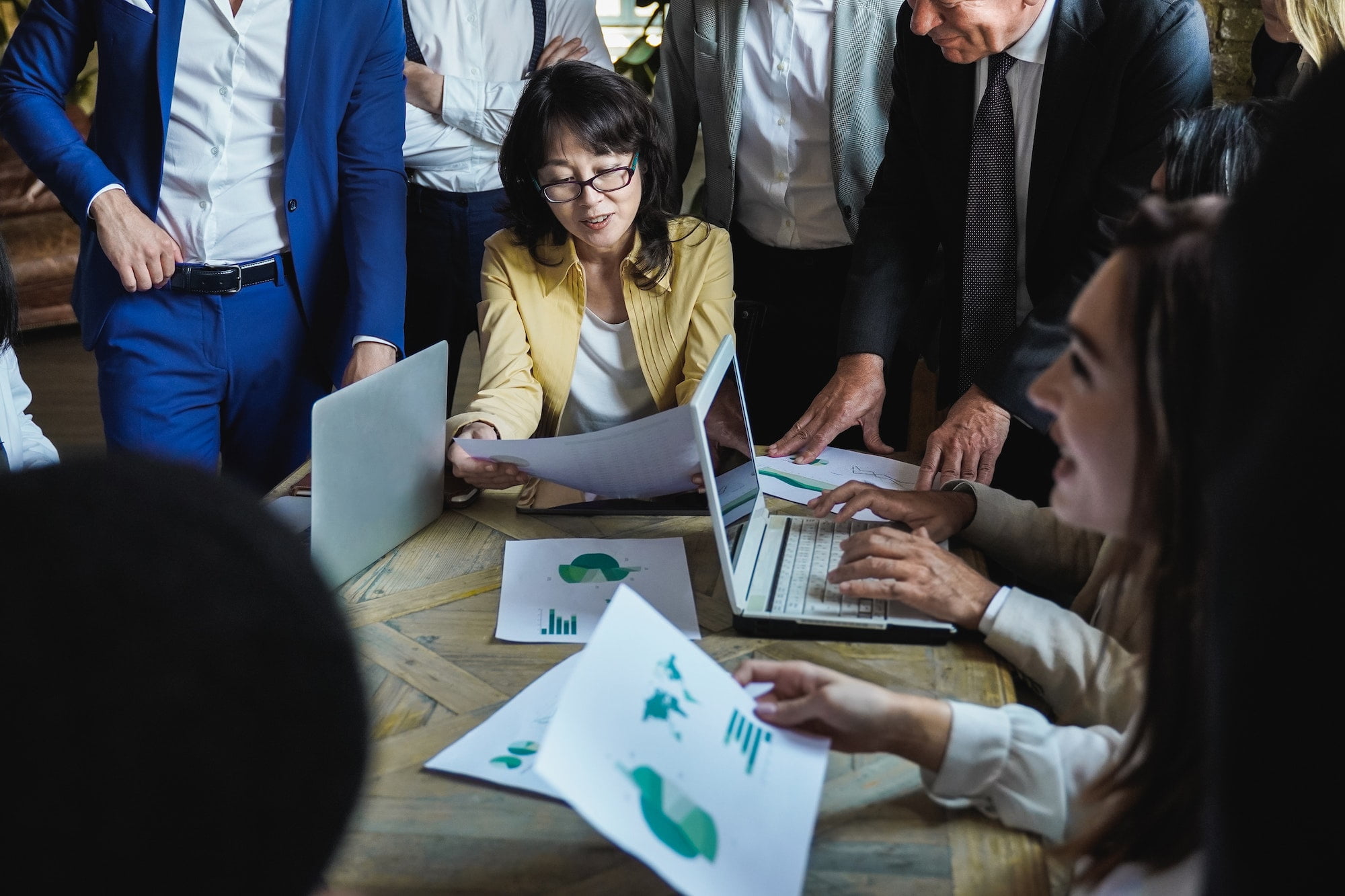 Multiethnic business people work on green sustainable project at office - Focus on Asian woman
